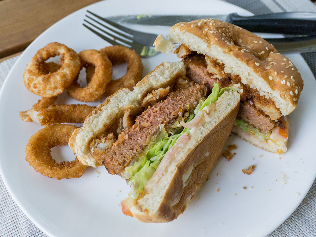 The Beyond Burger with onion rings cross section