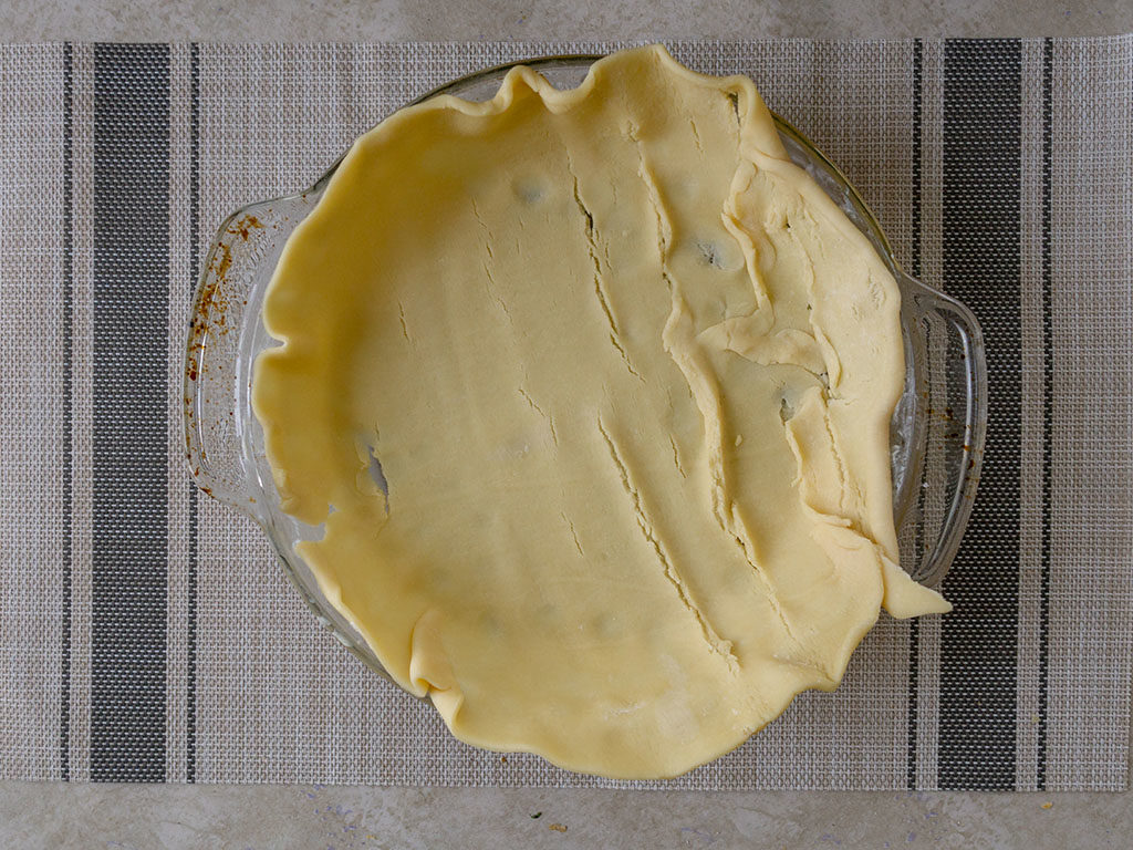 British beef and onion pie - lining baking dish with pastry