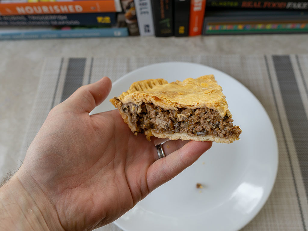 British beef and onion pie - refriegerated pie holding solid close up