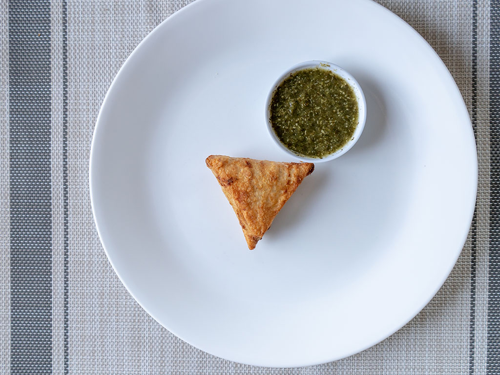 Sukhi's Chickpea Samosas cooked with sauce