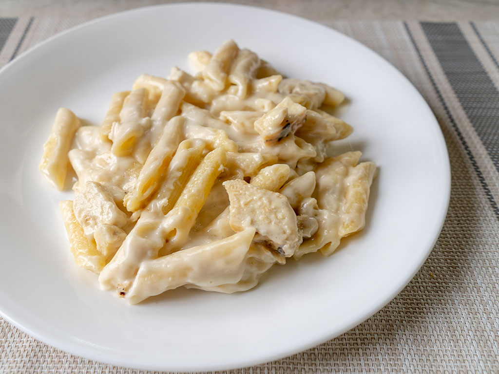 Three Bridges Chicken Penne Alfredo cooked side view