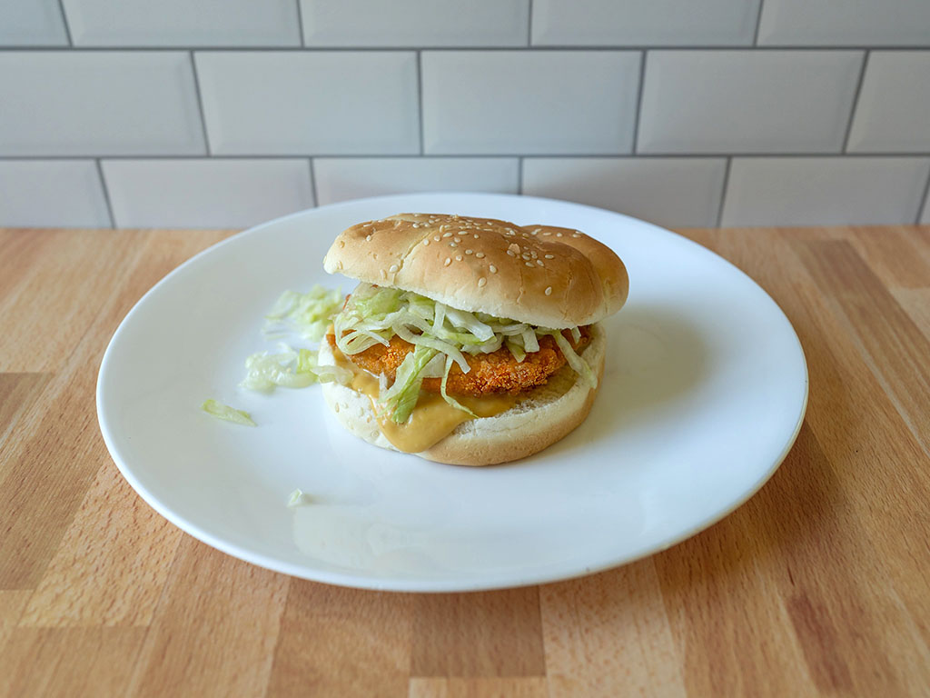 Tyson Frozen Chicken Patties on bun with lettuce and chicken sauce