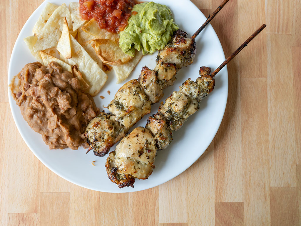 Whole Foods chicken kebob with chips, salsa, guac