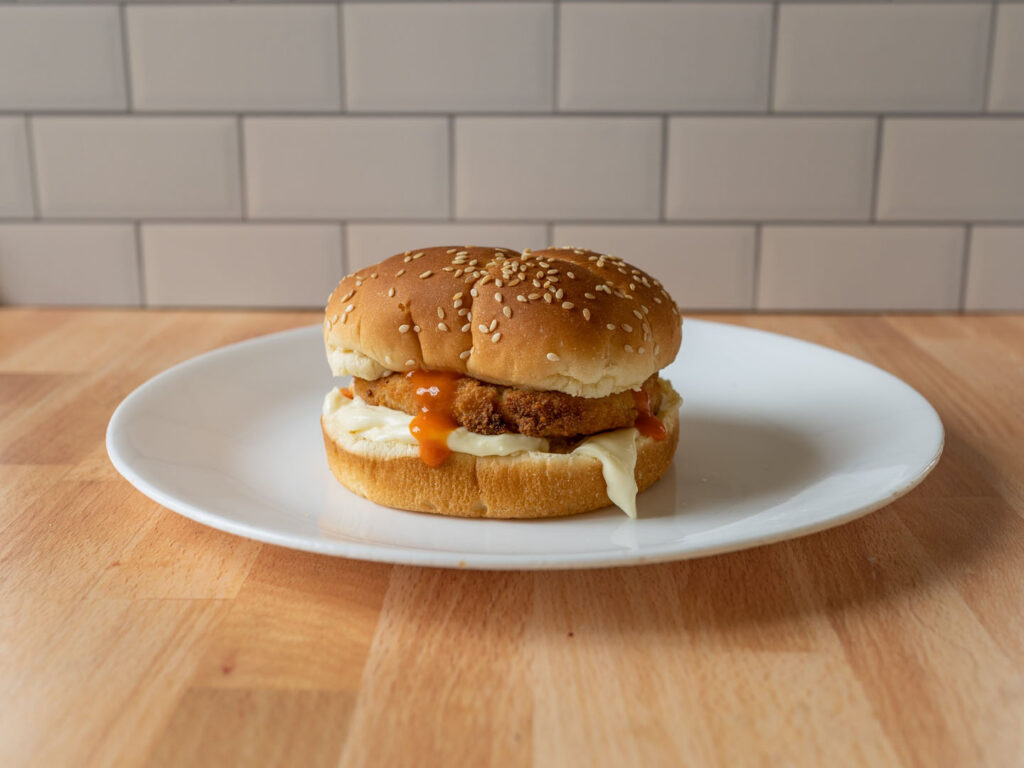 Applegate Naturals Chicken Burgers cooked on bun with sauce