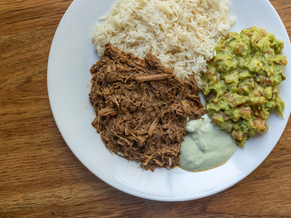 Del Real Barbacoa cooked with rice and guacamole close up