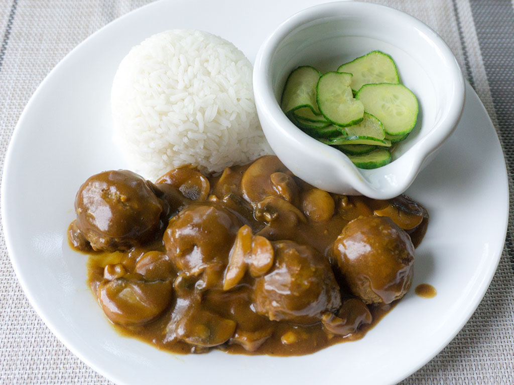 Gardein meatballs in Japanese curry with rice and sunomono above